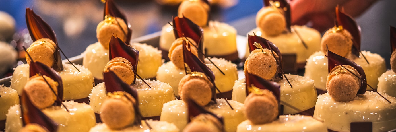 Une vendeuse en boulangerie dépose des tartelettes glacées sur le comptoir