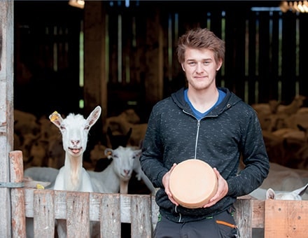 Producteur de fromage à base de lait de chèvre devant sa bergerie