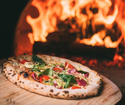 Pizza en gros plan devant un feu