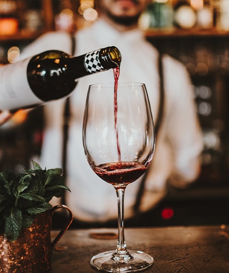 Serveur versant un verre de vin dans un restaurant