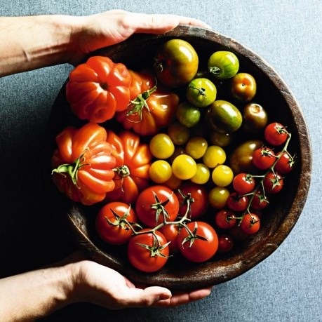 maini care tin un bol de lemn cu rosii - tomate mari, galbene,mici, rosii, verzi