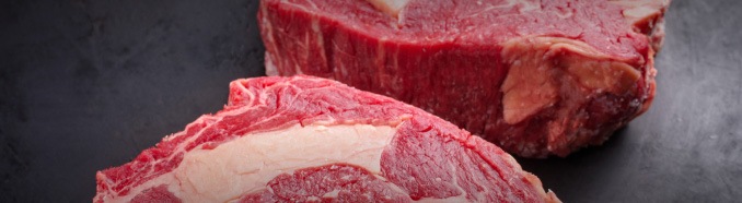 Bucăți de carne roșie proaspătă pe fundal închis – calitate METRO România.