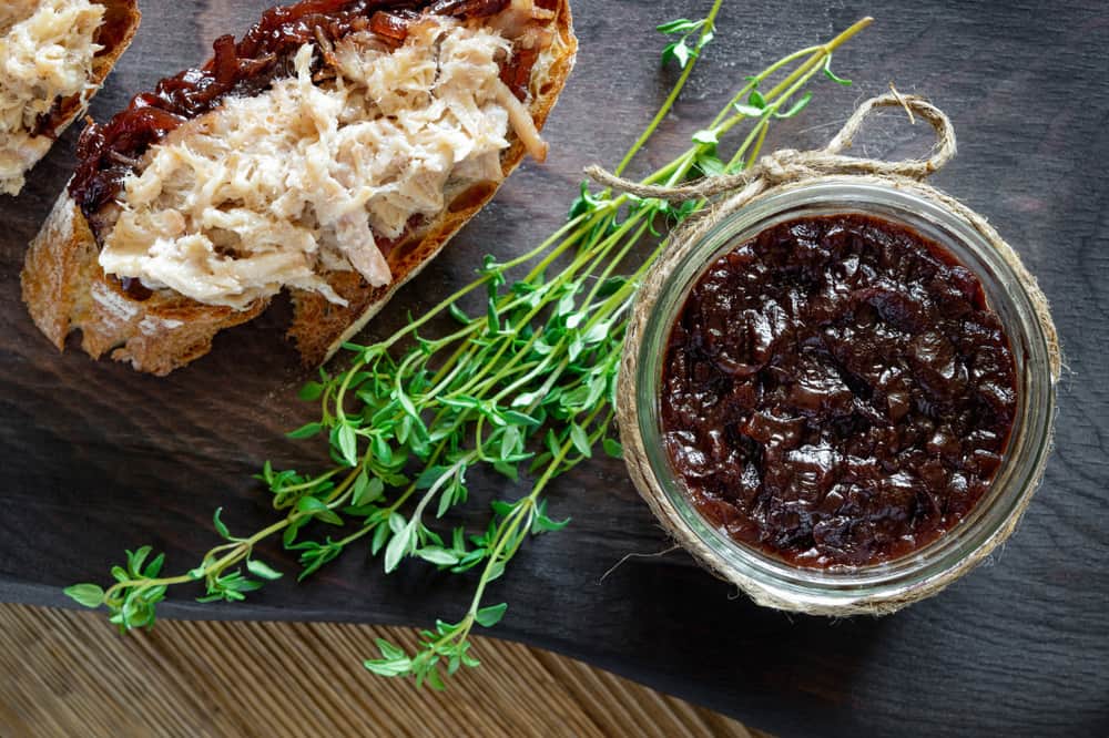 Хрусткий хліб із м’ясним паштетом і цибулевим конфітюром, прикрашений гілочкою чебрецю