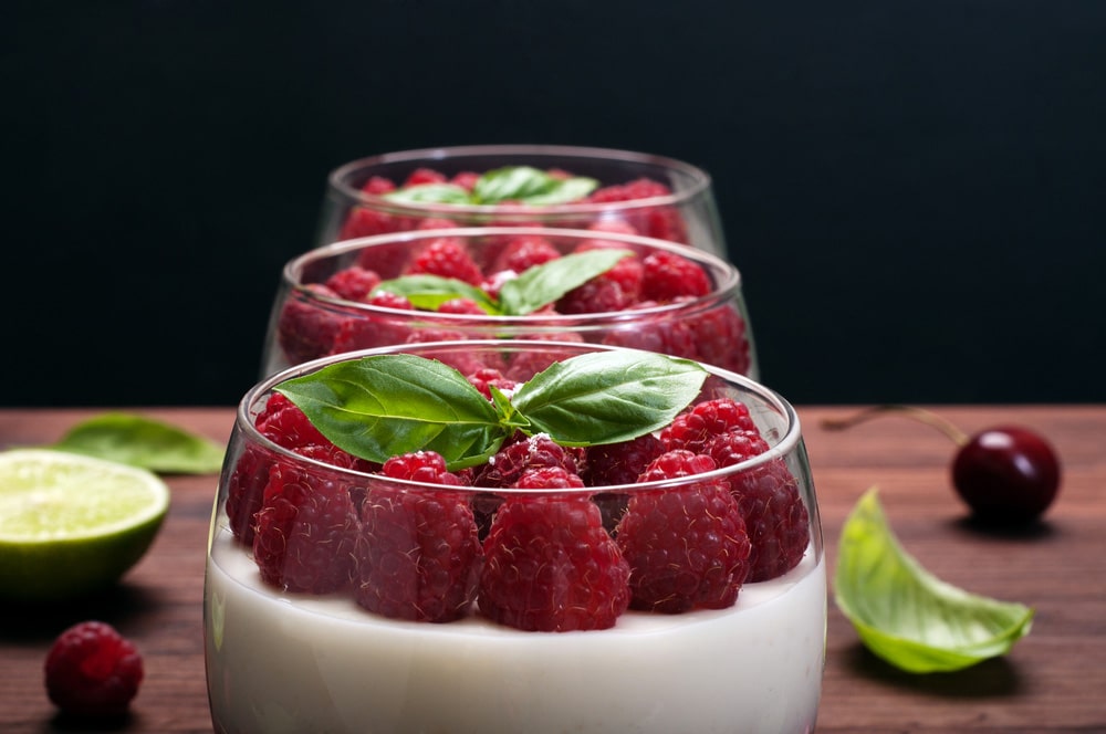десерт у склянках із йогуртом, малиною та листям базиліку